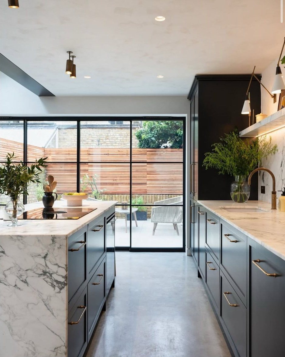Marble kitchen island with bespoke joinery and courtyard glazing on a Connolly refurbishment